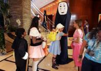 
Maganda Antonio, 11, hugs Sherri Kohli, 15, dressed as an 8-foot character from a Japanese animated movie, during the annual Anime Vegas convention Sunday at the Renaissance Hotel. Many who attended the dress-up party made their own costumes. 