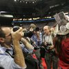 Journalists crowd Kendal Unruh of Colorado to get photographs of her hat,
decorated with homemade b