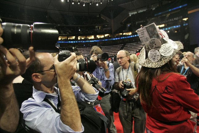 Journalists crowd Kendal Unruh of Colorado to get photographs of her hat,
decorated with homemade buttons, reflecting her excitement at Alaska Gov.
Sarah Palin's nomination for vice president. In Palin's speech on Wednesday
night at the Republican National Convention, Palin castigated the media for
the intense scrutiny on her since being named last week by Sen. John McCain
as his running mate.