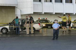 Las Vegas Metro Police crime scene analysts process a car at the Bally's port cochere as police investigate a fatal stabbing at the casino early Friday. 