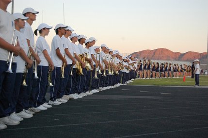The Foothill High School marching band and cheerleaders stand waiting for Friday night's game to start. 