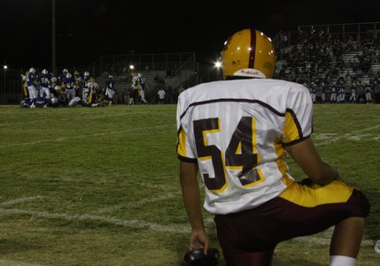 Eldorado No. 54 Adad Diaz watches Friday night's game against Basic from the sidelines. Basic won, 28-13.