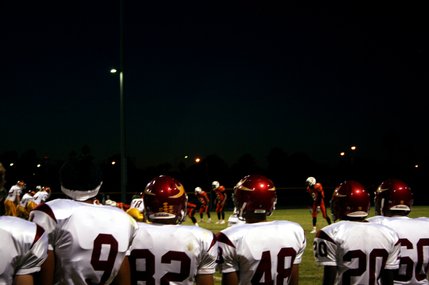 The Del Sol Dragons watch their teammates play the Chaparral Cowboys during Friday's game.