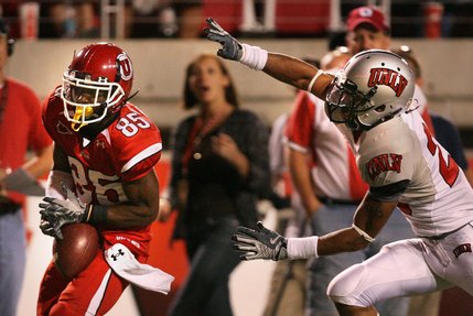Utah wide receiver Jereme Brooks almost lost his grip on this touchdown pass from Utah's Matt Asiata, but gathered it in to scamper for the 32-yard play. Chasing for UNLV is defensive back Terrance Lee.