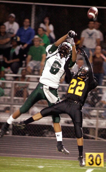 Marcos Gomez, right, of Clark High School, deflects a pass intended for Dijon Holman of Rancho High School during their game.