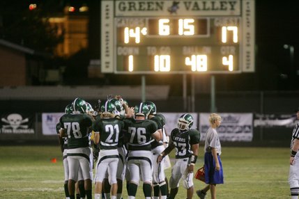 Green Valley's offensive line huddles during a time out on Friday night.