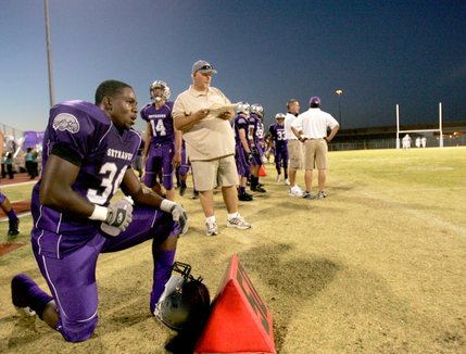 Silverado's Terran Madu-Jules, left, looks on from the sidelines after scoring his third touchdown of the evening during a home game against Mojave on Friday.