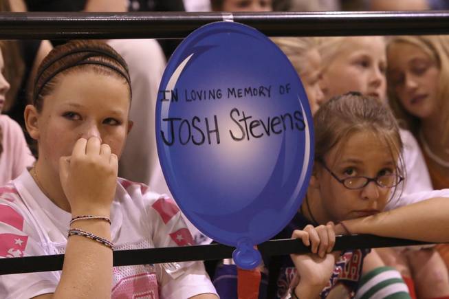 Jessica Weinman and Tia Noll, right, listen at a vigil in September 2008 at Bob Miller Middle School in honor of Josh Stevens, who died in a golf cart accident at the Anthem Country Club.