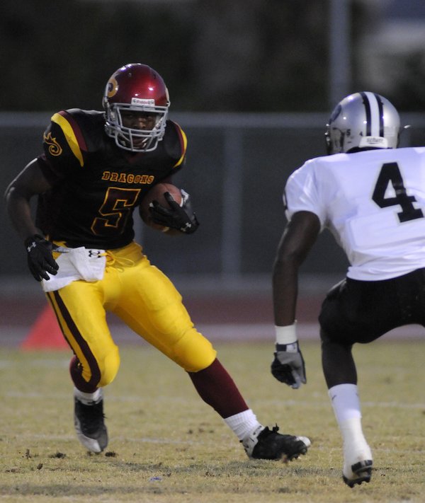 Dragon running back Earnest Hall (5) looks to sidestep Palo ...