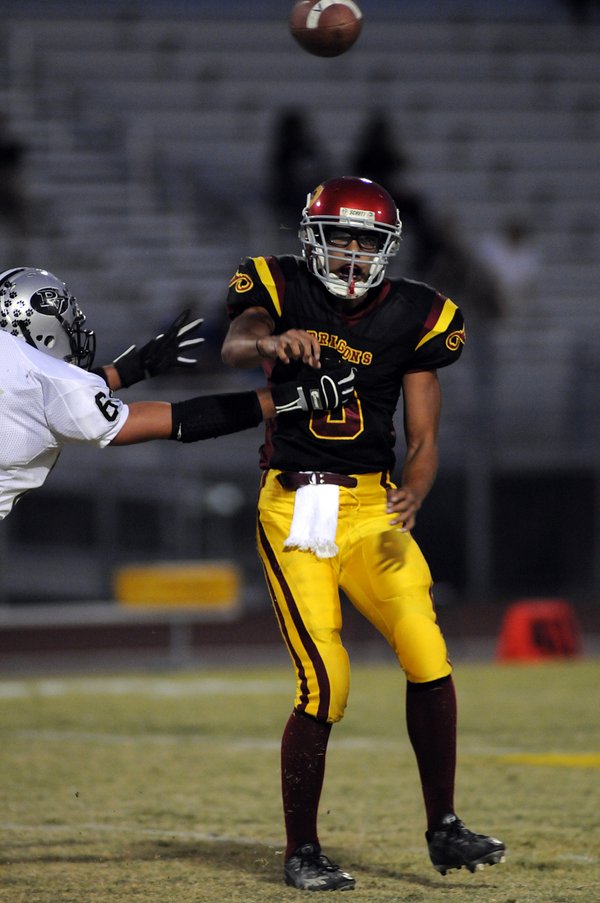 Dragons quarterback Saie HuiHui lets a short pass go while ...