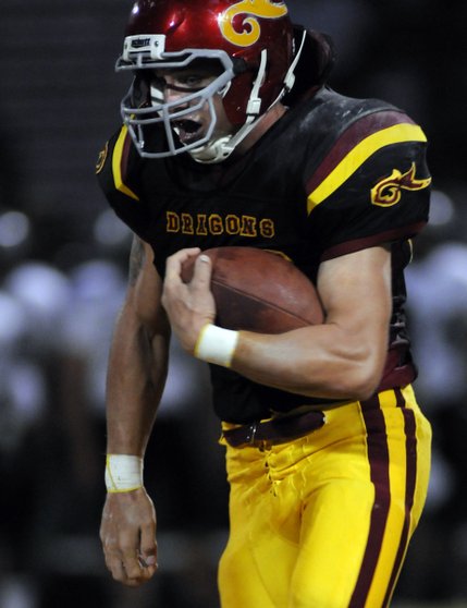 Dragons fullback Jon Kirschbaum takes the ball up field for a big gain against Palo Verde during a game at Del Sol High School on Sept. 12.