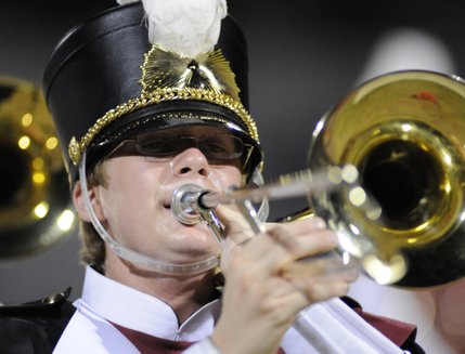Del Sol junior Dylan Musso plays the trombone during halftime of a football game between the Dragons and the Panthers at Del Sol High School on Friday.