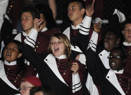 Del Sol High sophomore Shelby Self, center, and her fellow bandmates cheer for the Dragons from the bleachers during the second half of a game against Palo Verde on Friday.