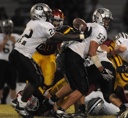 Panthers running back Chaz Thomas (22) nearly fumbles a bad hand off behind the line of scrimmage in the second half of Friday's game against the Dragons at Del Sol High School.