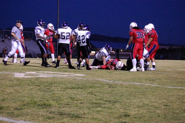 Senior running back Carlos Tautoto (32) is stopped by Durango's ...