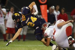 River Valley defensive back Nick Rowe brings down Boulder City linebacker Jeremy Smith during the season home opener at Boulder City High School on Friday.