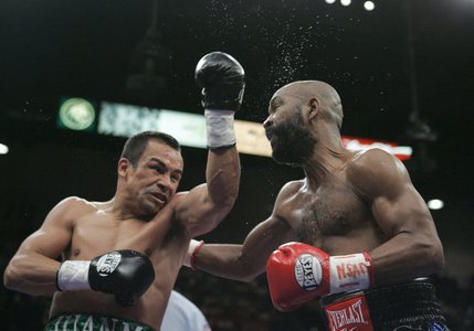 Lightweight boxer Juan Manuel Marquez of Mexico (left) connects with Joel Casamayor of Cuba during a lightweight fight at the MGM Grand Garden Arena.