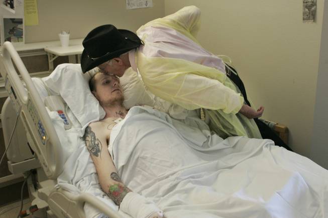 Burke comforts burn victim Shane Walsh, 27, who has been hospitalized since a motorcycle accident in January. 