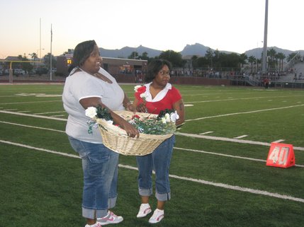 LaQuan Phillips' family accepts flowers during the Green Valley game against Arbor View Friday. LaQuan was temporarily paralyzed after a tackle during last Friday's game.