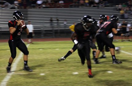 Las Vegas senior quarterback Emir Lopez looks for an open receiver during Friday's game verses Pine View.