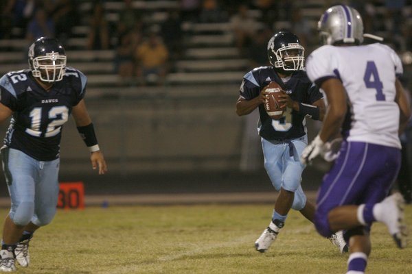 Centennial quarterback Chris Henderson (3) looks to pass during Friday ...