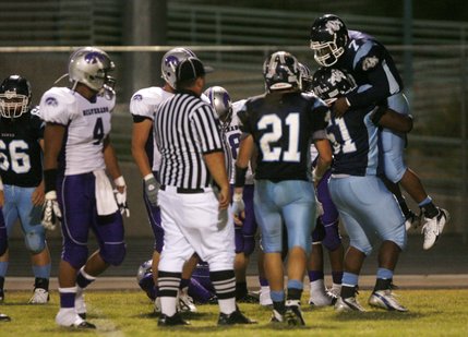 Centennial running back Brandon Wright (7) is lifted up by teammates after scoring a touchdown during Friday night's home game against Silverado.
