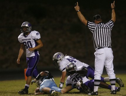 A referee signals touchdown after Centennial's Matt Holley (on the ground) scores during a home game against Silverado on Friday.