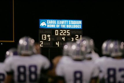 Players look at the final score: Silverado 21, Centennial 0. 