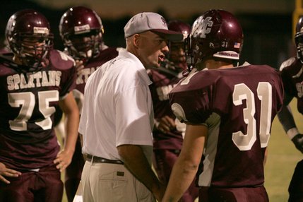 Cimarron-Memorial head coach Rod Vollan talks with Zach Barbara (31) between plays during a home game against Desert Pines Friday night.