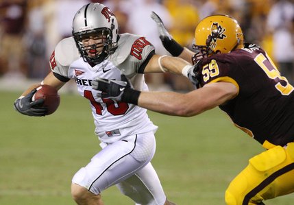 UNLV defensive back Beau Orth, left, runs with the ball after making an interception as Arizona State tackle Jon Hargis, right, tries to stop him during the second quarter.