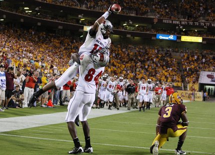 UNLV receiver Phillip Payne, top, celebrates with teammate Rodelin Anthony (84) after Payne beat Arizona State defensive back Omar Bolden (3) for a touchdown in the second quarter.