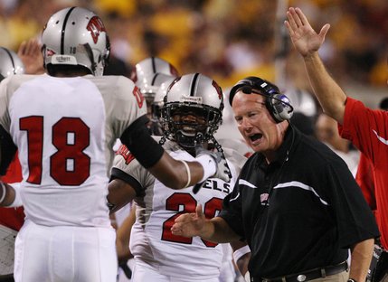 UNLV receiver Phillip Payne (18) celebrates with head coach Mike Sanford, right, and teammate David Peeples, center, after Payne scored a touchdown against Arizona State in the second quarter.