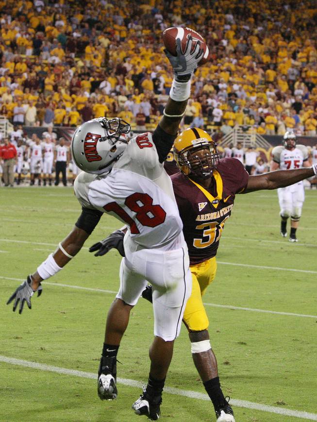 UNLV receiver Phillip Payne (18) makes a one-handed catch for a touchdown against Arizona State defensive back Pierre Singfield late in the fourth quarter on Sept. 13, 2008. The Rebels won the contest, 23-20, in overtime.