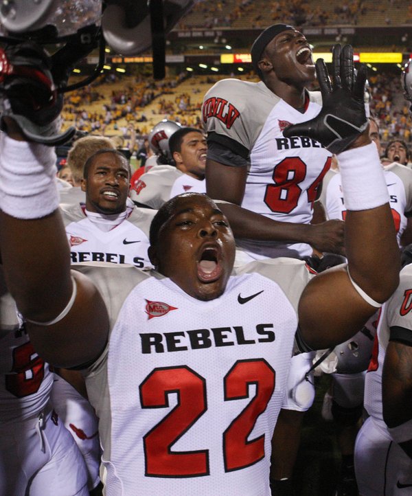 UNLV players Wiselet Rouzard (22) and Rodelin Anthony, top, right, ...