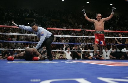 Lightweight boxer Juan Manuel Marquez, right, of Mexico celebrates after knocking out Joel Casamayor of Cuba during the 11th round of their lightweight title match at the MGM Grand Garden Arena Saturday.