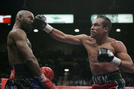 Lightweight boxer Joel Casamayor of Cuba, left, takes a big punch from Juan Manuel Marquez of Mexico during their lightweight title fight Saturday night at the MGM Grand Garden Arena in Las Vegas. Marquez knocked out Casamayor in the 11th round to claim the Ring Magazine crown.