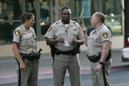 Lt. George Glasper, center, talks with other court marshals as they wait for O.J. Simpson to arrives for the first day of his trial at the Clark County Regional Justice Center in Las Vegas, Nev., Monday, Sept. 15, 2008. Simpson is facing charges that include burglary, robbery and assault following an alleged robbery at the Palace Station Hotel & Casino in September, 2007. 