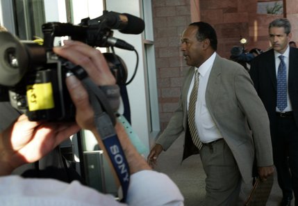 O.J. Simpson enters the Clark County Regional Justice Center for the first day of his trial in Las Vegas, Nev., Monday, Sept. 15, 2008.  Attorney Gabriel Grasso follows at left. Simpson is facing charges which include burglary, robbery and assault following an alleged robbery at the Palace Station Hotel & Casino in September, 2007. 
