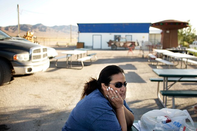 Little A'Le'Inn owner Connie West sits outside her bar, restaurant and gift shop recently in Rachel, where residents have until Monday to come up with the money to appeal the Planning Commission's decision on a private prison.