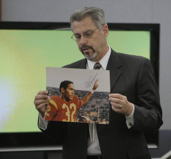 Bruce Fromong displays a signed photo entered into evidence  during O.J. Simpson's trial in Las Vegas, Tuesday, Sept. 16, 2008. 