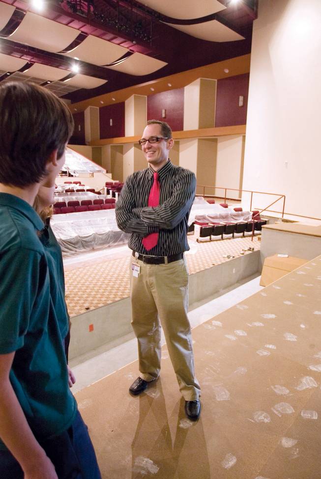 Drama Director Erik Ball, right, talks with performing arts students Timothy Heidorn and Kaitlin Barker inside the yet-to-be-completed new performing arts theater at Faith Lutheran High School.