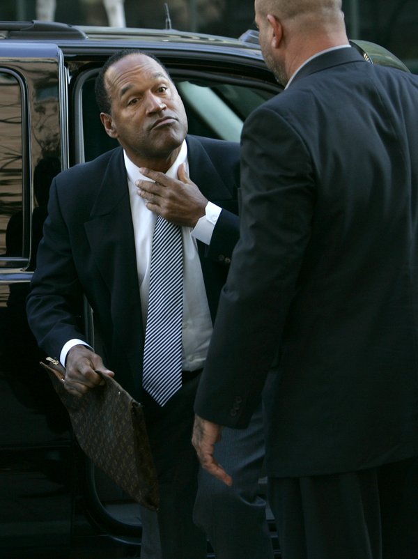 O.J. Simpson adjusts his tie as he arrives at the ...