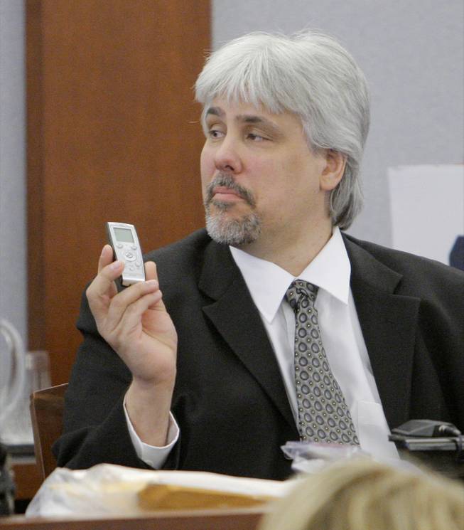 Collectibles dealer Thomas Riccio holds up an audio recorder as he testifies Thursday afternoon, Sept. 18, 2008, during O.J. Simpson's trial at the Clark County Regional Justice Center in Las Vegas. Simpson faces charges that  include burglary, robbery and assault following an alleged robbery at the Palace Station Hotel & Casino in September  2007. 