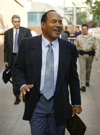 O.J. Simpson smiles as he arrives for his trial Thursday, Sept. 18, 2008, at the Clark County Regional Justice Center in Las Vegas. 