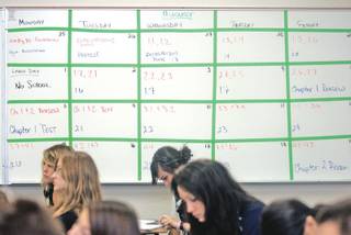 The calendar of class lessons and assignments in algebra teacher Josh Adams' classroom helps keep students on track as well as increasing their responsibility to make up work when absent.