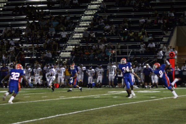 Sam Aigbe (34) and D'ere Moore (8) try to intercept ...