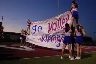 Valley High School cheerleaders wait to welcome the Vikings to the field on Friday. 