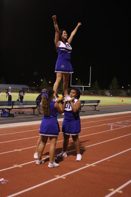 Desert Pines cheerleaders pump up the crowd during Friday night's game.