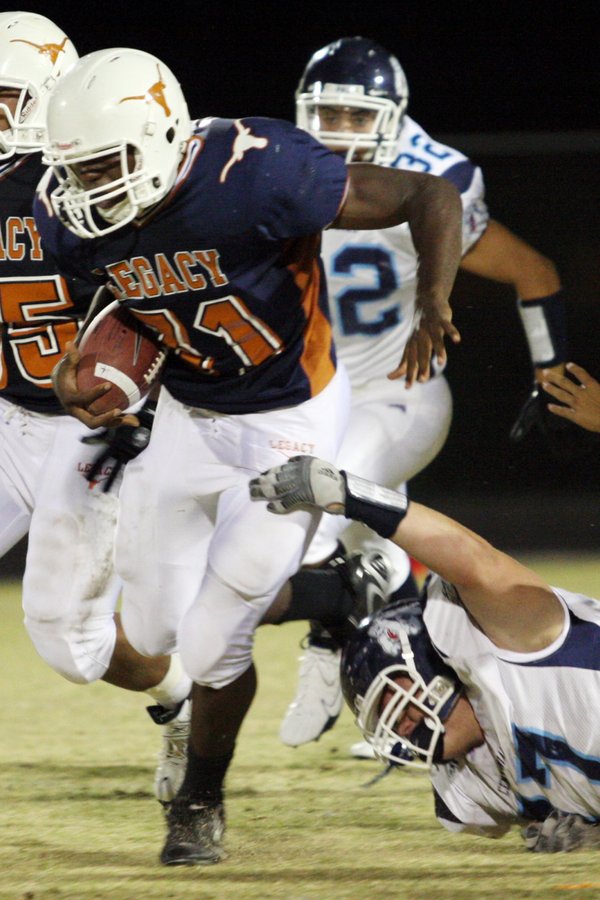 Centennial defensive lineman Billy Smith, right, attempts to take down ...