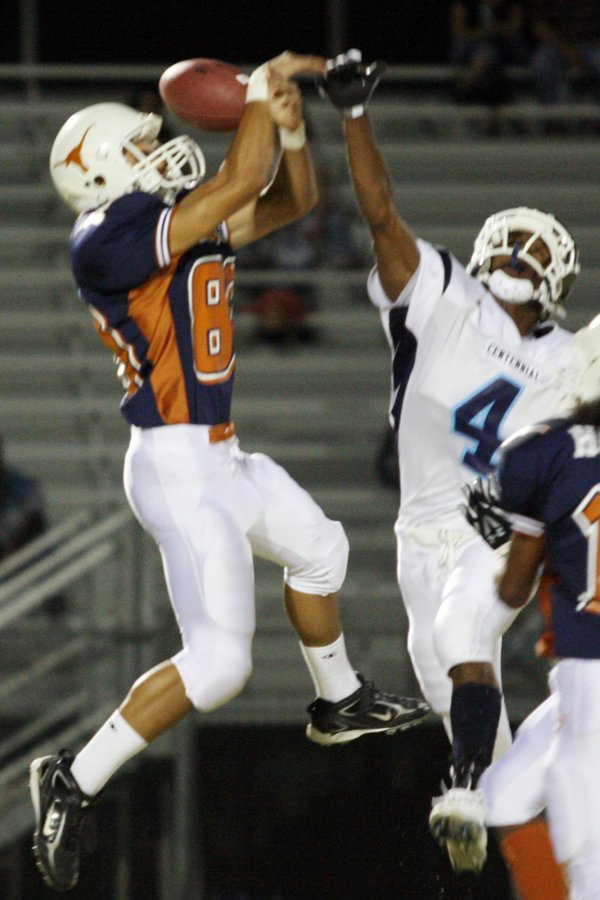 Centennial defensive back Brandon Wright, right, keeps the ball away ...